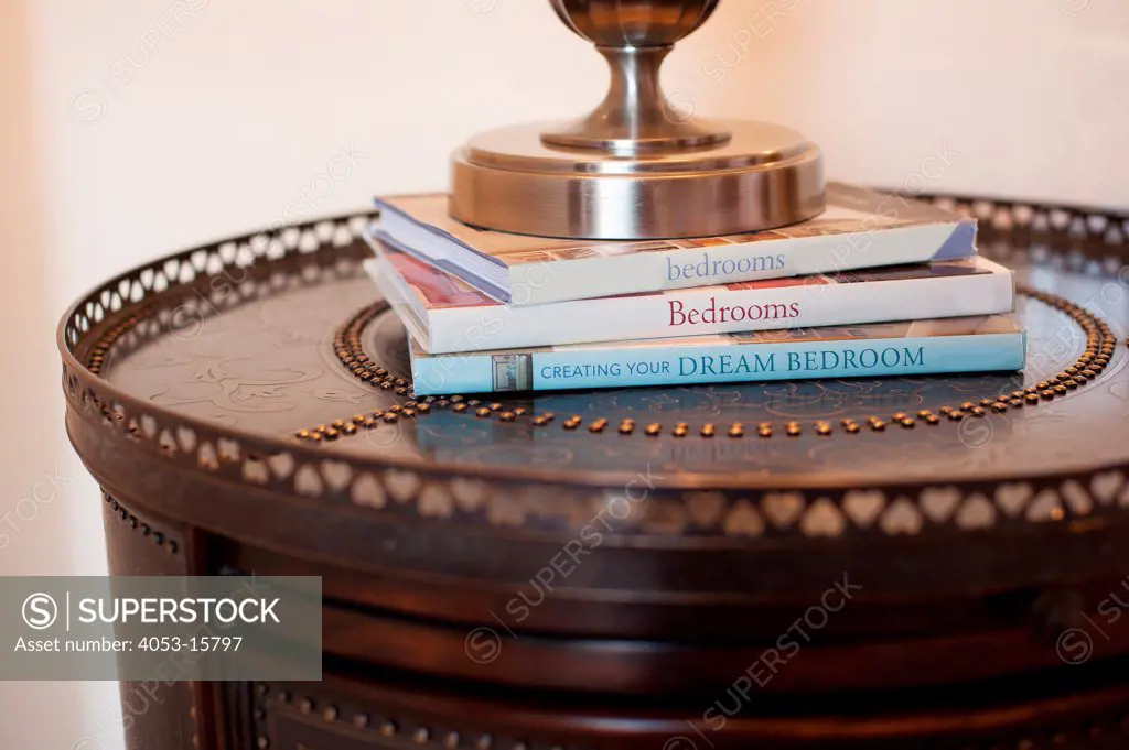 Close-up of books with lamp holder on console table against blurred background, Scottsdale, USA. Arizona, USA. 01/25/2013