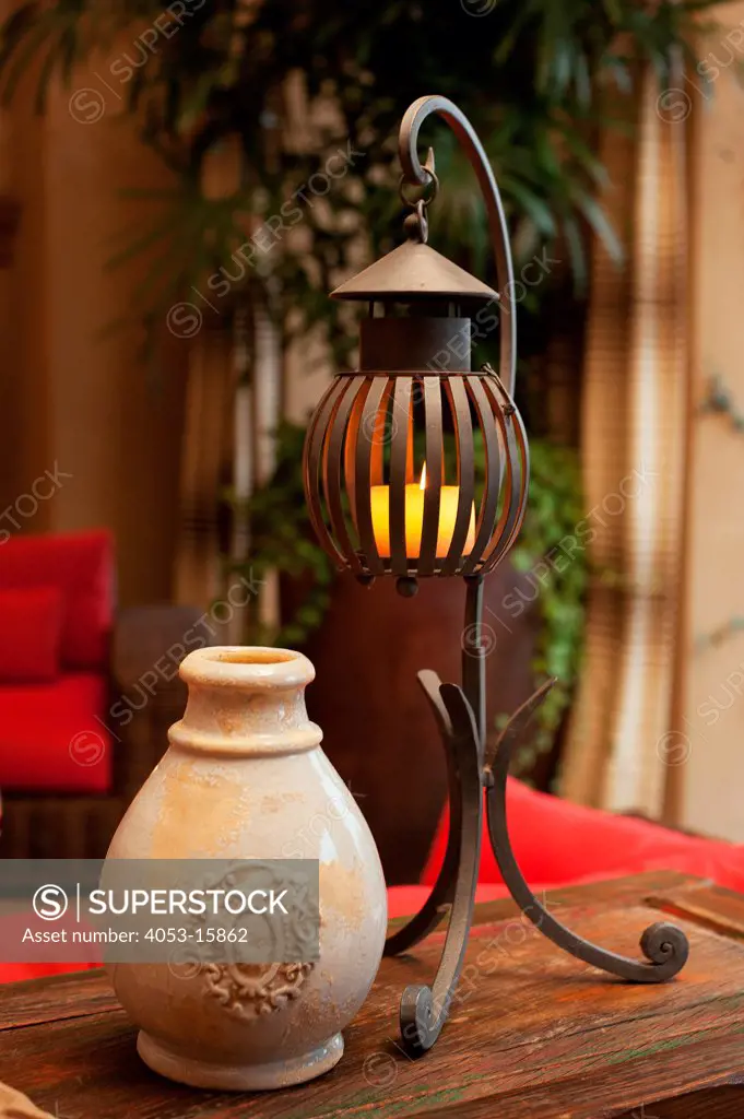 Close-up of a pot with candle lantern on table at home, Scottsdale, USA. Arizona, USA. 01/25/2013