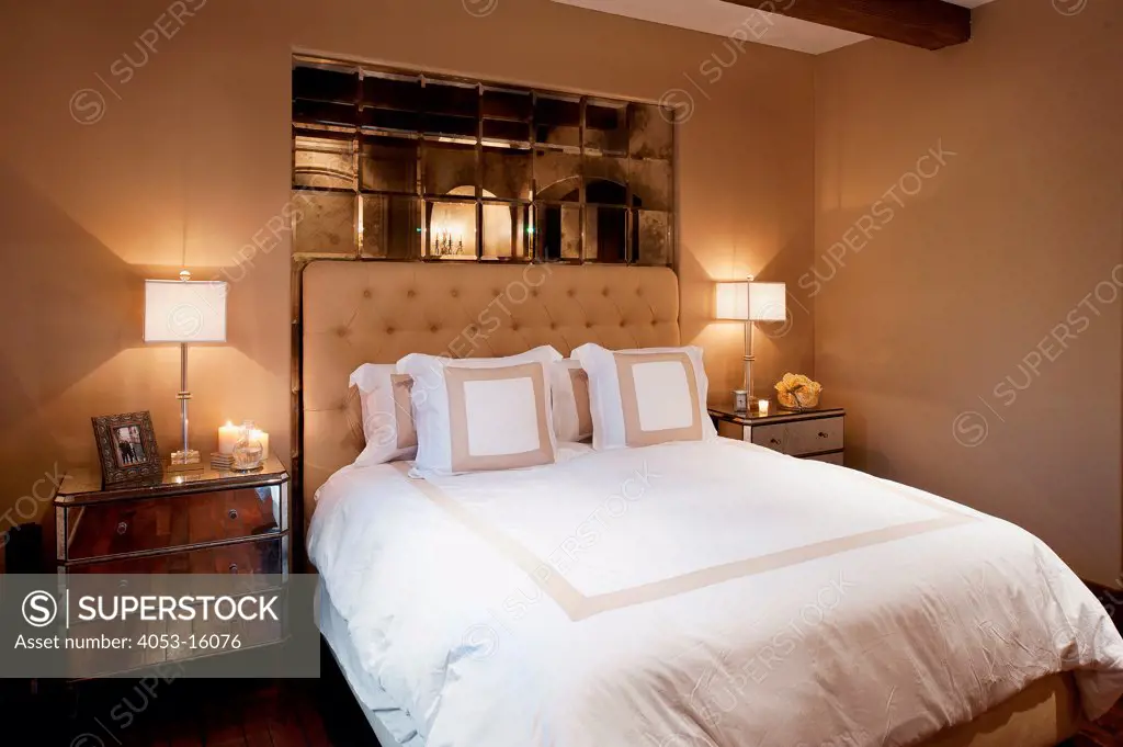 Lit lamps on side tables by cozy and tidy bed in bedroom at home, Rancho Sante Fe, USA. California, USA. 01/23/2013
