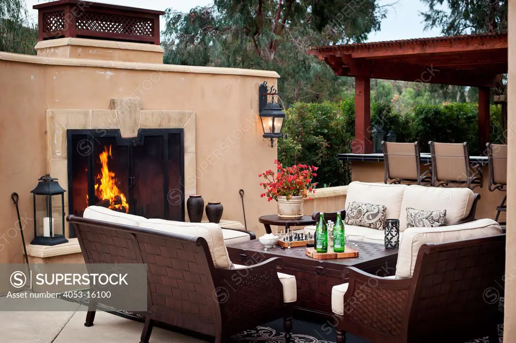 Outdoor furniture by fireplace at patio, Rancho Sante Fe, USA. California, USA. 01/23/2013