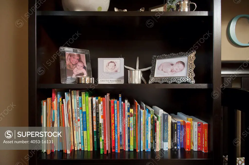 Close-up of books and picture frames in shelves. California, USA. 01/23/2013