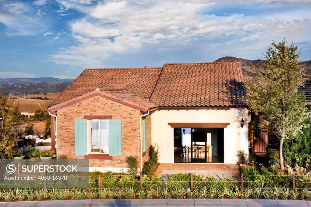 Front exterior of one story house against cloudy sky, Rancho Mission Viejo. 07/09/2013