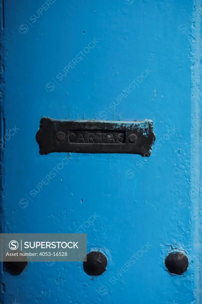 Close-up of mail slot in blue door, Havana, Cuba. 11/29/2010