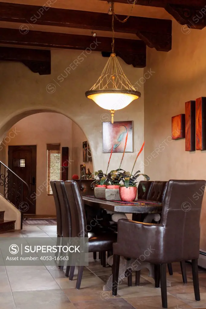 Leather chairs around wooden dining table exposed beams in house, Santa Fe, New Mexico, USA, 08/08/2012