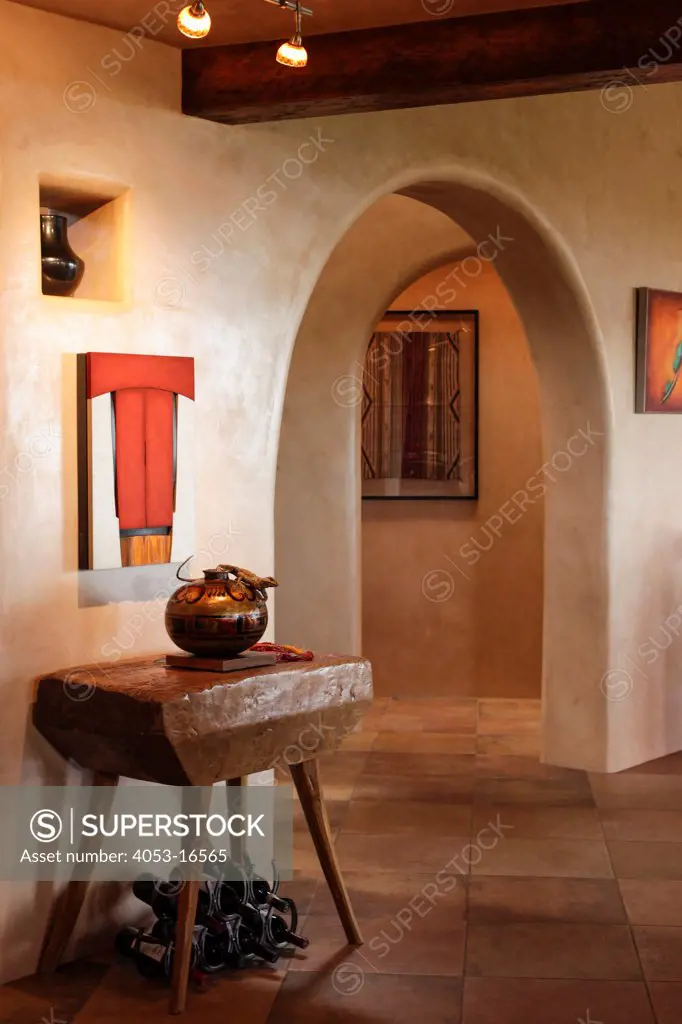Antique pot on console table with archway along hallway at home, Santa Fe, New Mexico, USA, 08/08/2012