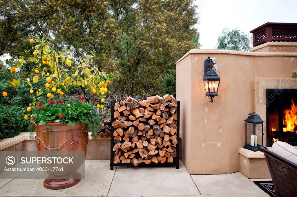 Stacked logs by fireplace in courtyard, Rancho Sante Fe, CA, USA, 18593 Calle La Serra. 01/23/2013