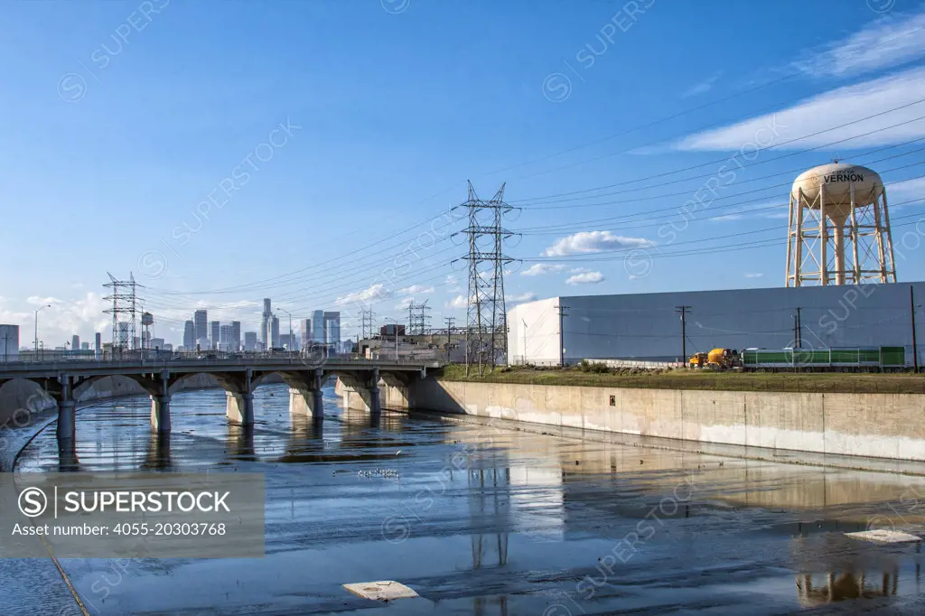 The Los Angeles River with the Vernon water tower and the Los Angeles skyline in the background, California, USA