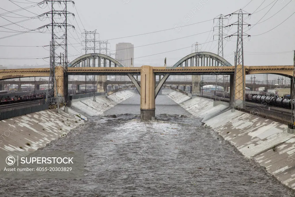 The 6th Street Bridge over the LA River as it rises dramatically when a big rainstorm brings much needed water to the Los Angeles area on December 2, 2014. Downtown Los Angeles, California, USA
