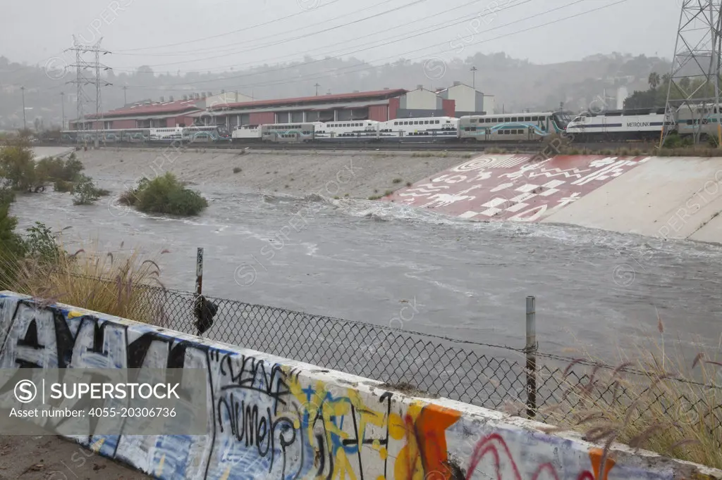 The LA River rises dramatically when a big rainstorm brings much needed water to the Los Angeles area on December 2, 2014. The Confluence, Los Angeles, California, USA