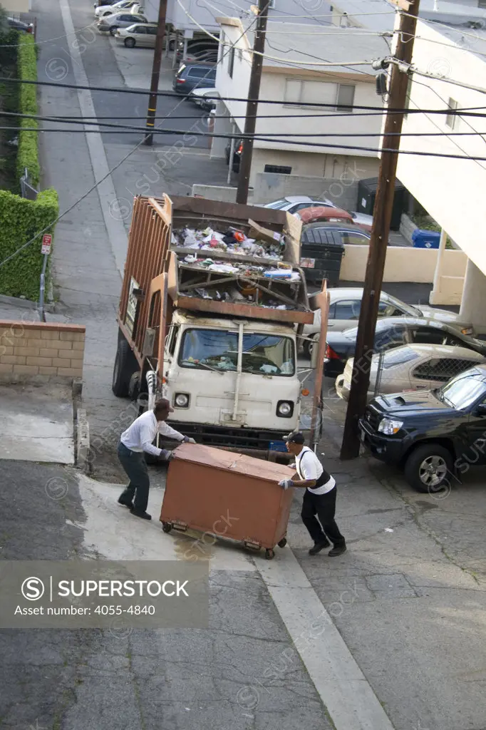 Garbage Truck picks up dumpsters of non-recyclable trash in West LA alley, In 2008 Los Angeles launched SWIRP (Solid Waste Integrated Resources Plan) which will include pick up of recyclable refuse from multi-family units, California, USA