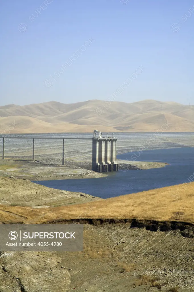 The San Luis Dam and San Luis Reservoir is a water-storage ""off-stream"" reservoir and is typically low in late summer due to its heavy usage for irrigation, Merced County, California, USA