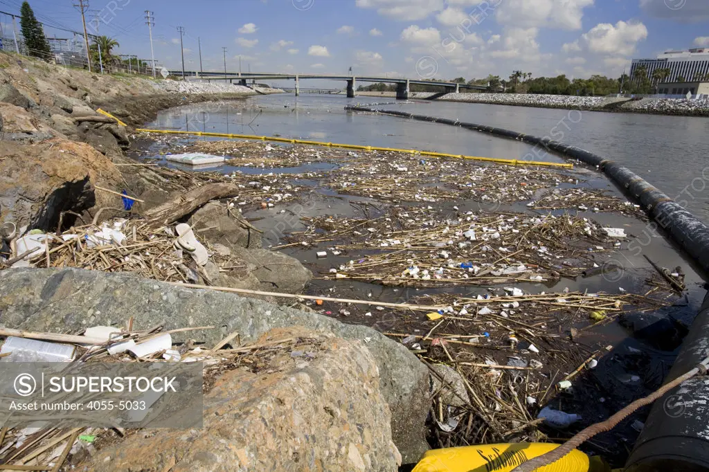 The Garbage boom on the Los Angeles River in Long Beach was built in 2001. Urban runoff carries an assortment of trash and debris from catch basins where a network of pipes and open channels create a pathway to the Ocean. The man made debris can include plastic bags and bottles, Styrofoam cups, cans, tires, and household furniture. After the first major storm of the season, the boom may collect over 50,000 pounds of trash.