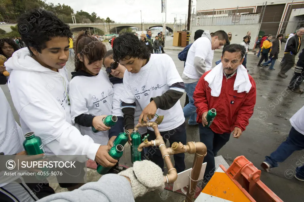 Hispanic youths filling up water metal water bottles. March for Water, World Water Day 2009, in downtown Los Angeles. March 22, 2009. A community march highlighting the local state water crisis that has resulted from a dysfunctional management