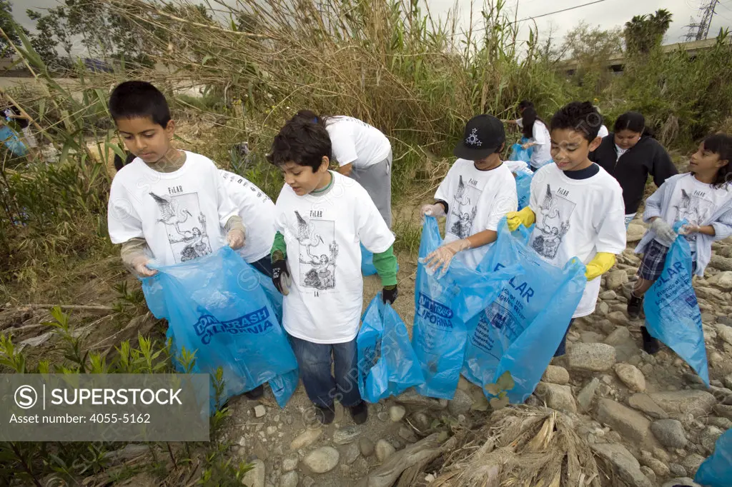 Students from local schools at FoLAR's River School Day of the LA River. This half-day event gives students an opportunity to participate in a River cleanup and educational activities that teach about the connection between storm drains, the River a the ocean and the importance of healthy watershed management. Los Angeles, California, USA.