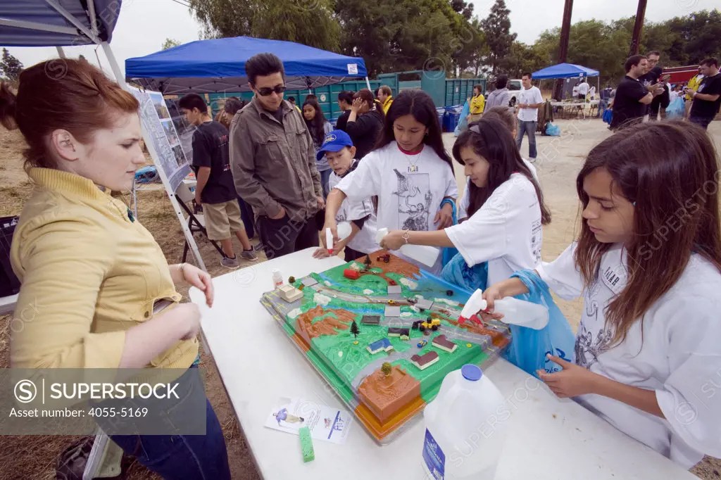 Erin First for CalTrans: Dont Trash California, with a watershed demonstration, illustrating how rain flows over roads and lawns, collecting toxic runoff and polluting water bodies and the underground water supply.