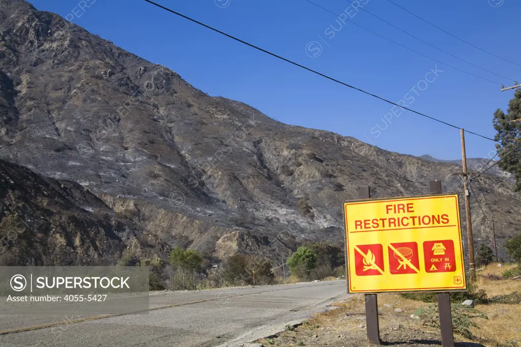 Fire Restrictions sign in with Devastation from Station fire in background, Sept 5 2009. Big Tunjunga Canyon Road, San Gabriel Mountains, Angeles National Forest, Los Angeles, California ,USA