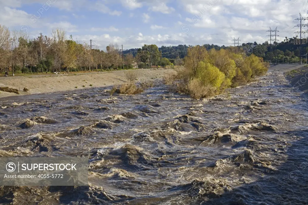Currents increase and waters rise dramatically in the Los Angeles River during rainstorm. Glendale Narrows. Los Angeles, California, USA