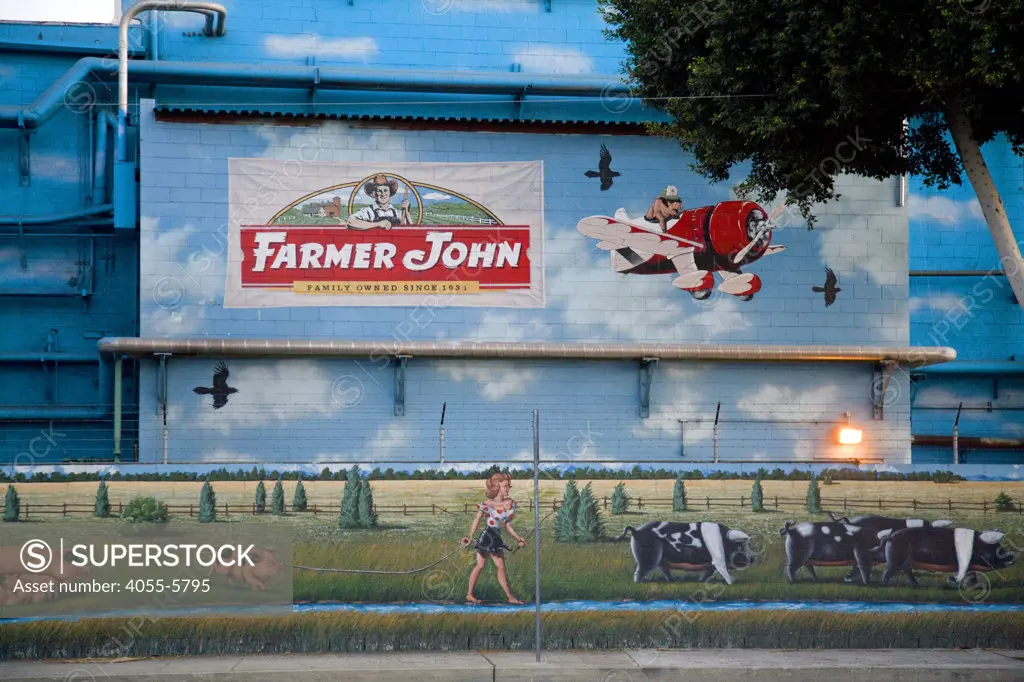 Mural on the side Farmer John meat processing plant in Vernon. Farmer John produces a variety of Pork products. Located just a few miles from downtown Los Angeles, Vernon's official slogan is ""Exclusively Industrial"" and at the last census had a population of 91. Los Angeles, California, USA