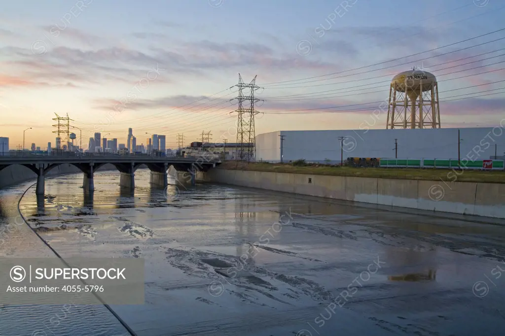 Vernon's Water tower along the Los Angeles River with downtown in the background. Vernon's official slogan is ""Exclusively Industrial"" and at the last census had a population of 91. Los Angeles, California, USA