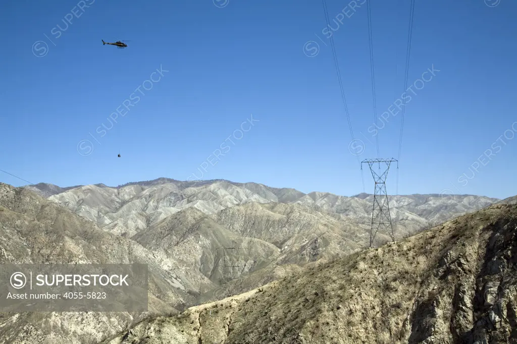 Helicopter brings heavy machinery for electrical crews to install. In April, 2010, about six months after the Station Fire, re-growth has yet to appear in some of the burn areas of the in Angeles National Forest.