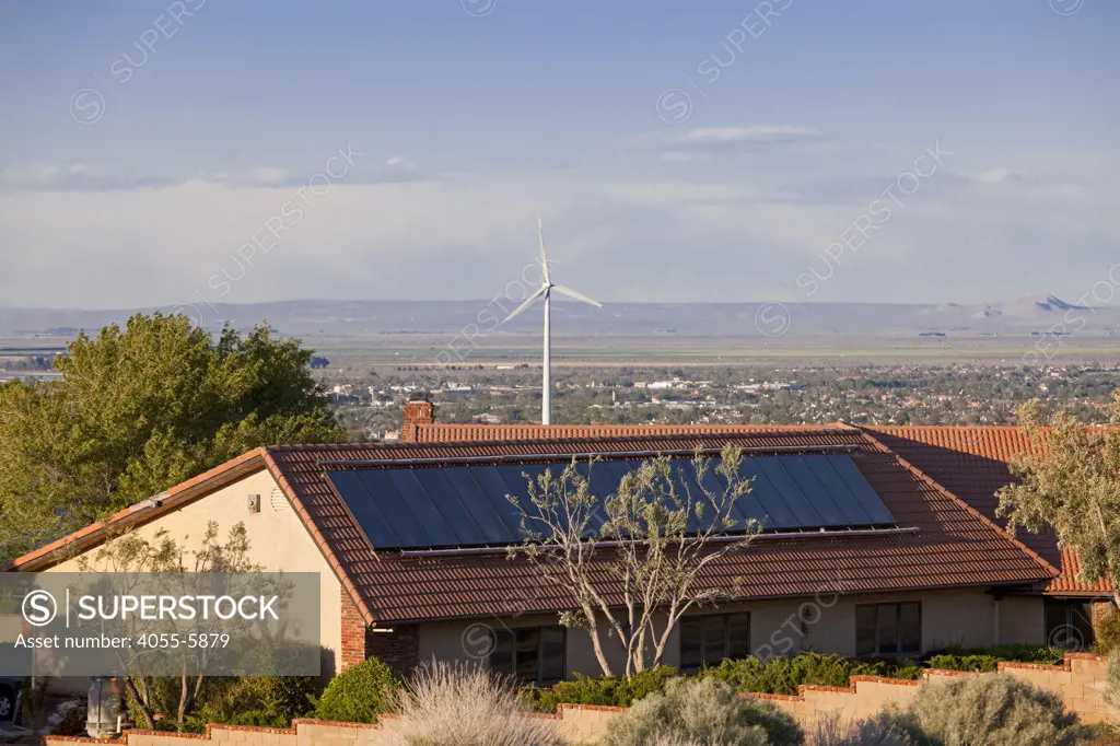 Solar panel on roof of home with wind turbine in background, Housing developments in Palmdale, the city has consistently been ranked in the top 25 fastest growing cities in the United States, Los Angeles County, California, USA