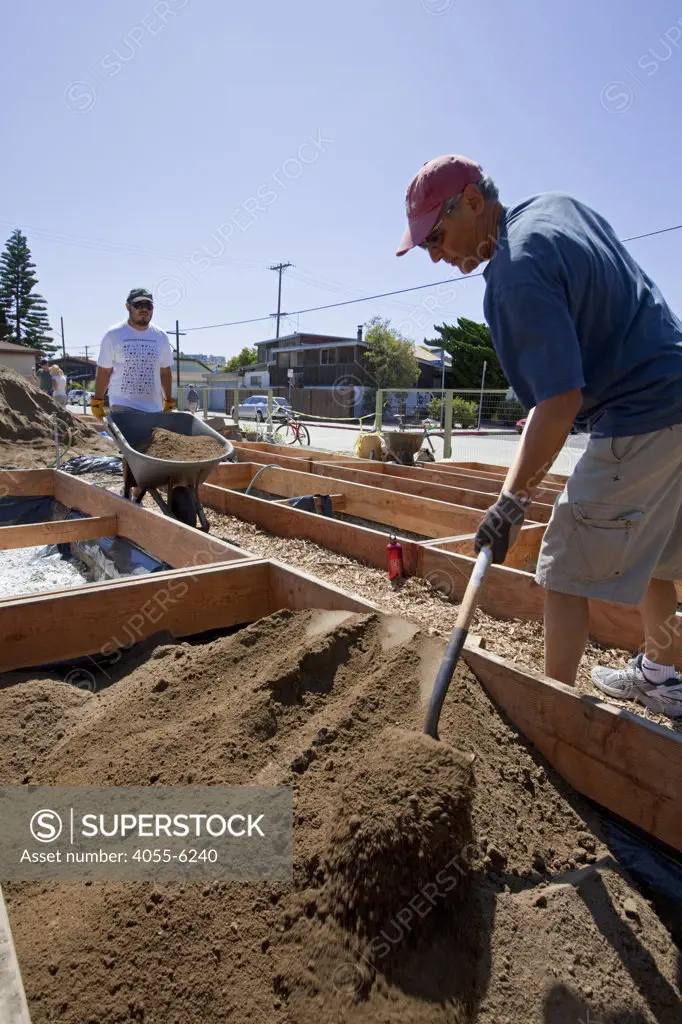 July 24, 2010. Laying down the soil for the final preparations of the planting beds at the Venice Community Garden. The 2 foot deep beds are layered with 3 inches of rocks as a buffer between the roots and the bad soil below, but will still allow water to drain.