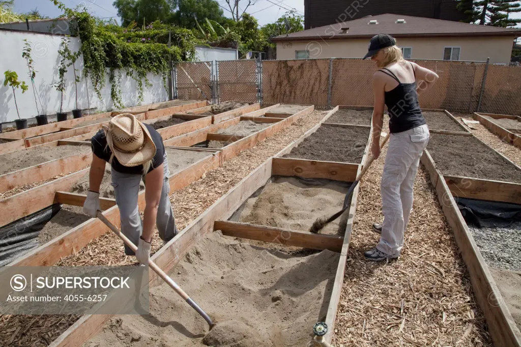 August 14, 2010. Isabel and Aeryn fill their planting box with the newly arrived soil. The Venice Garden broke ground in April, 2010. Soil tests revealed high levels of arsenic and lead because of previous uses which included a railroad line going through the lot. Steps were taken which included adding protective layers and adding new soil. Planting began in August and the first harvest was in October, 2010. Venice, California, USA