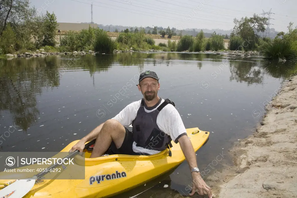 Kayaker George Wolfe of the LaLa Times. FoLAR' (Friends of the LA River) annual river cleanup, La Gran Limpieza, was held  May 9, 2009. Thousands of volunteers at 14 sites pulled out accumlated trash, mostly plastic bags, from river runoff that might normally find it's way downstream into the Pacific Ocean.