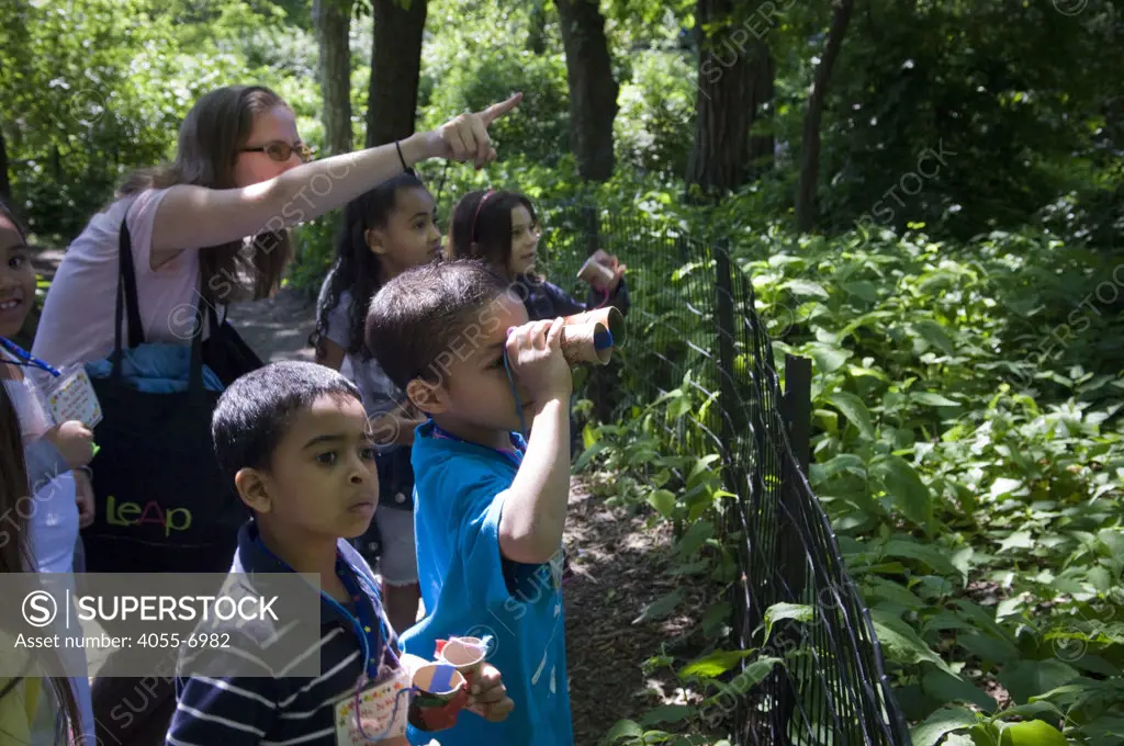 First grade students from PS 14X go birding in Central Park in New York on Thursday, May 20, 2010. The students participate in LeAp's Active Learning Leads to Literacy Program,  a program that teachers literacy through the arts. The students hand crafted their binoculars out of toilet paper tubes.   (© Frances M. Roberts)