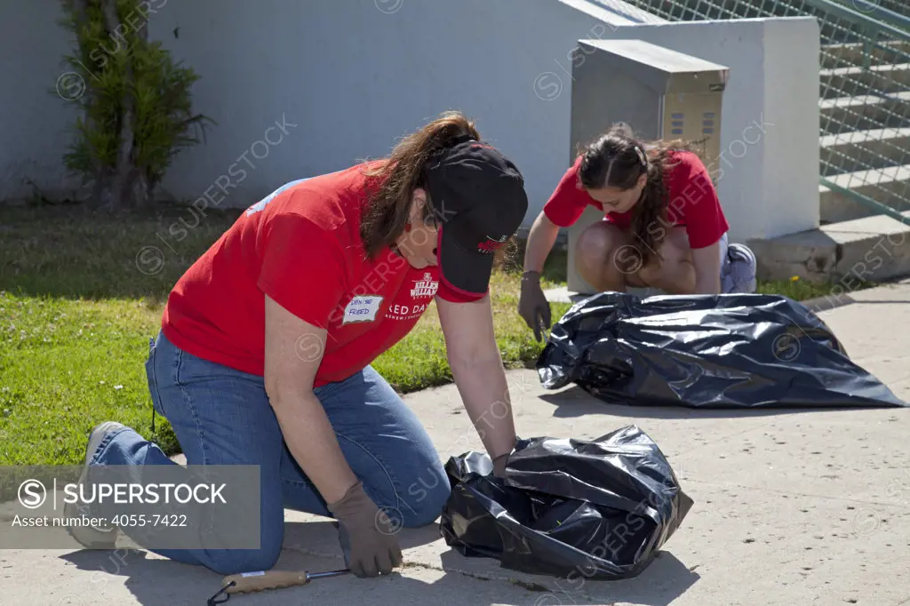 Keller Williams volunteers help clean up at John Adams Middle School in Santa Monica. More than 30,000 associates from  Keller Williams Realty across the United States and Canada participate in the third annual RED Day, May 12, 2011. RED Day, which stands for Renew, Energize and Donate,  is a collective service initiative where the companys associates donate a day to give back to the community. Santa Monica, California, USA
