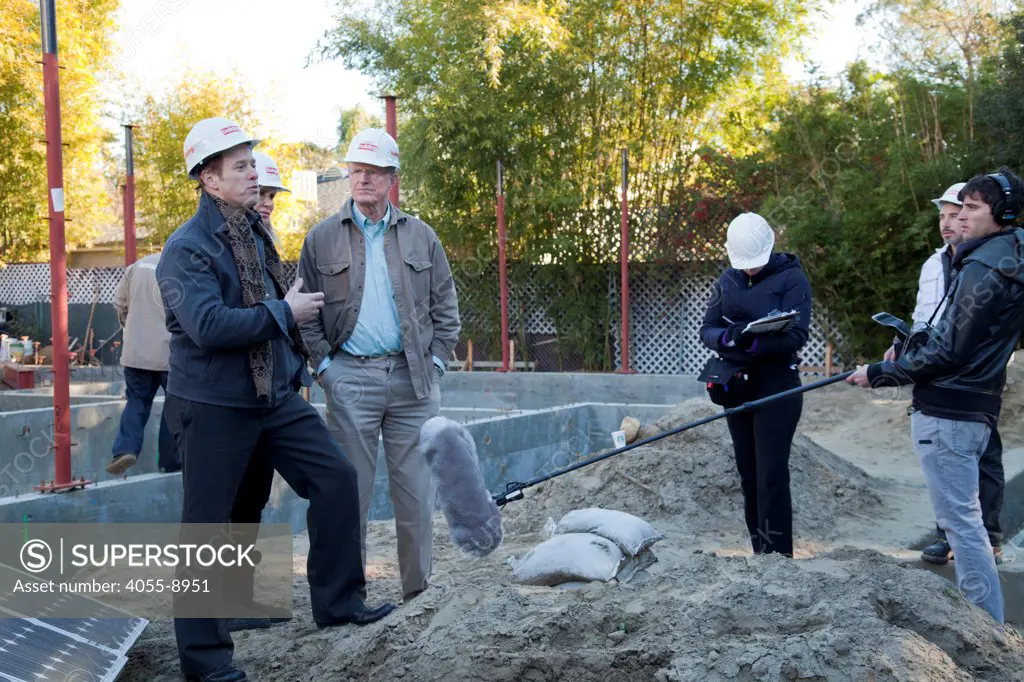 Raphael Sbarge, executive producer of ""On Begley Street"" interviewing Ed Begley Jr.. Steel framing began on 1/14/2013 over the foundation on the Begley's new home.  Studio City, California, USA
