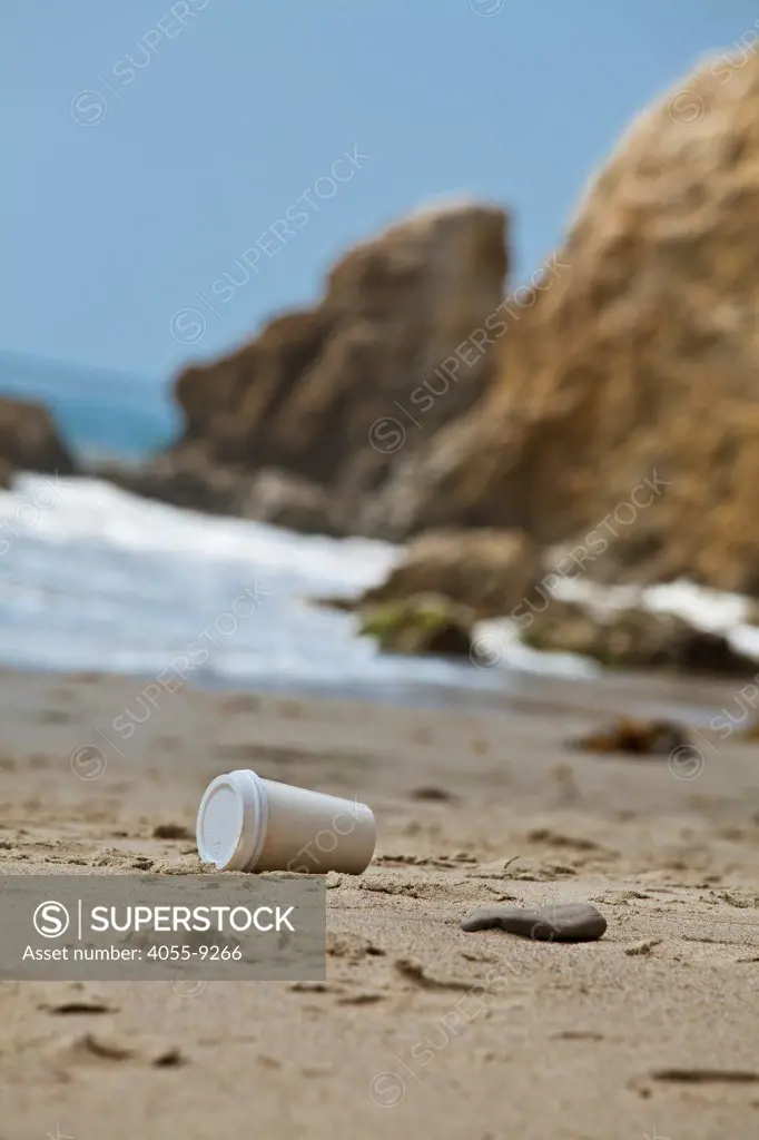 Littered coffee cup on El Matador State Beach, Malibu, Los Angeles County, California