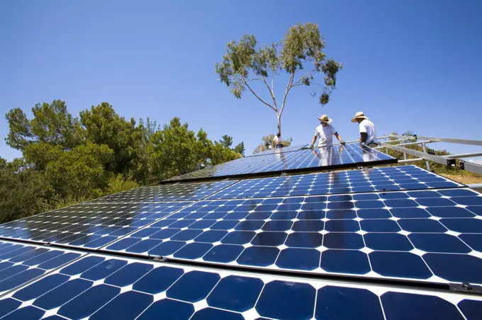 Workers install a solar array on a hillside in Malibu, Installation by Martifer Solar USA, California, USA