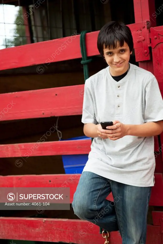 Teenage boy text messaging on a mobile phone, Orlando, Florida, USA