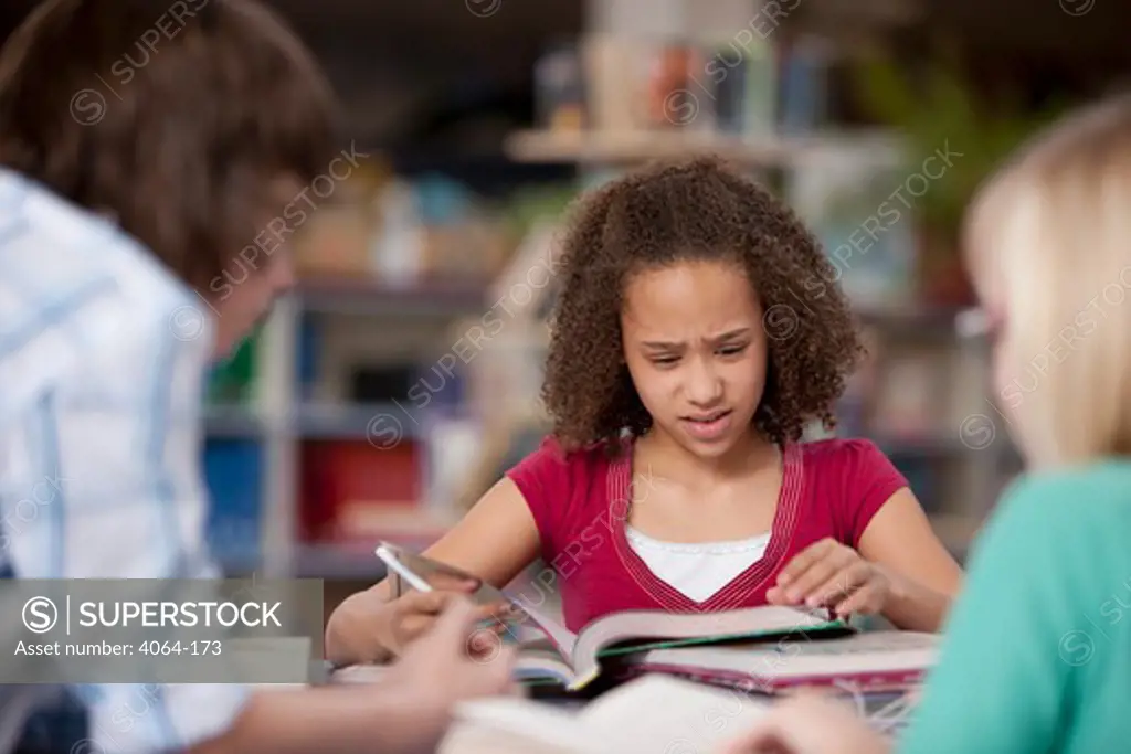 Middle school student studying in a library