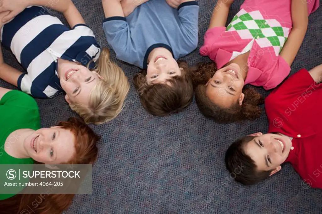 Huddle of middle school students smiling in school