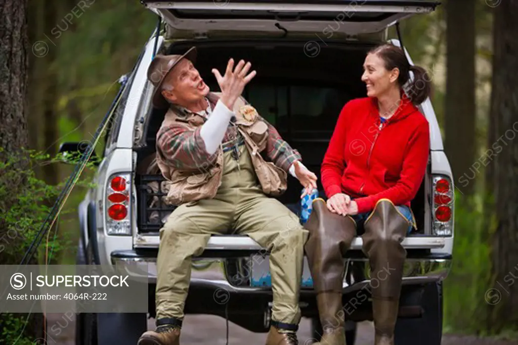 USA, Washington, Vancouver, Smiling couple sitting in back of car after fishing