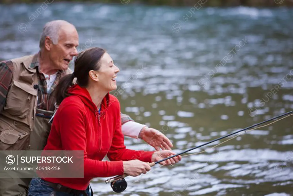 USA, Washington, Vancouver, Smiling couple fishing in river