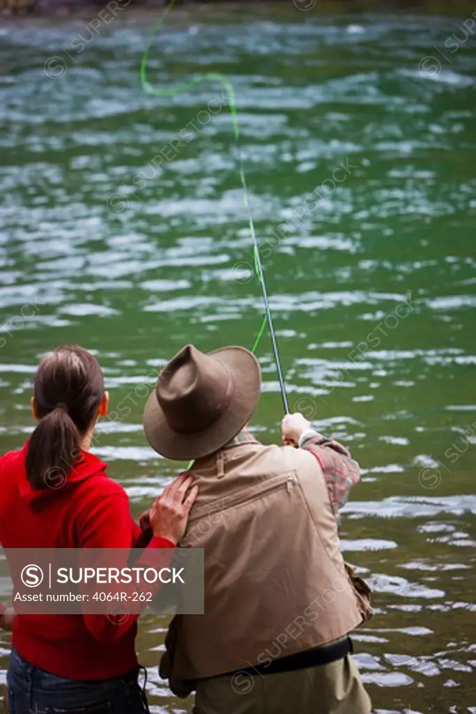 USA, Washington, Vancouver, Rear view of couple fishing in river