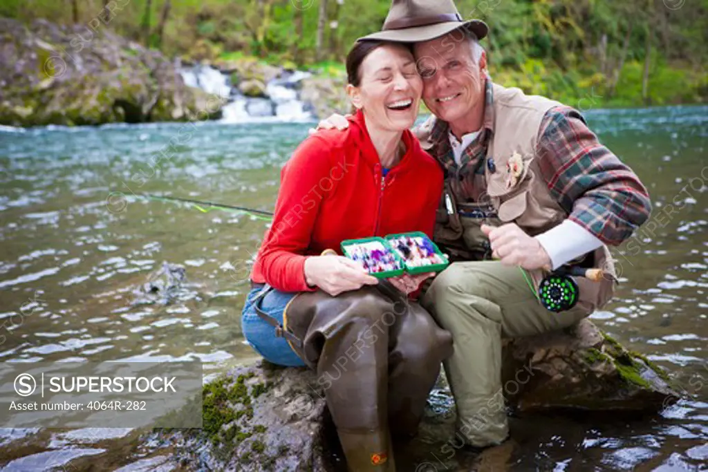 USA, Washington, Vancouver, Portrait of smiling couple fishing in river