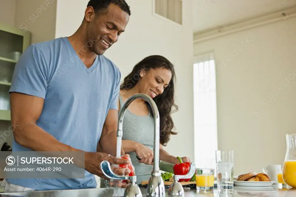 Couple making breakfast in loft apartment