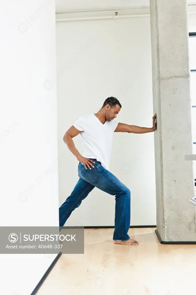 Man stretching in loft apartment