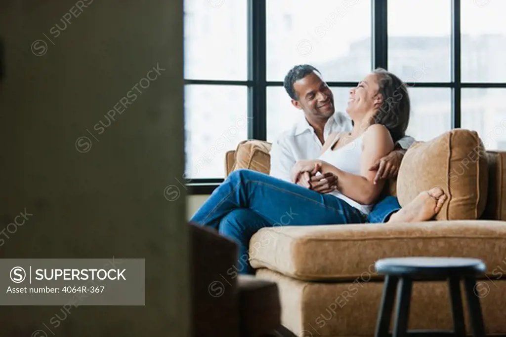 Couple relaxing on couch in loft apartment