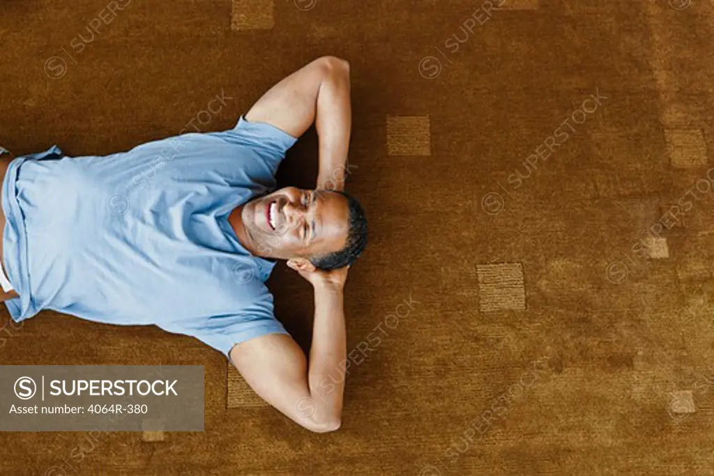 Man relaxing on floor in loft apartment