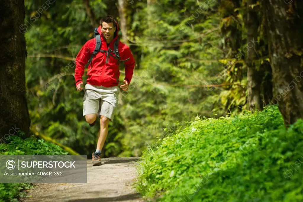 Portland, Oregon, USA, Man trail running with backpack