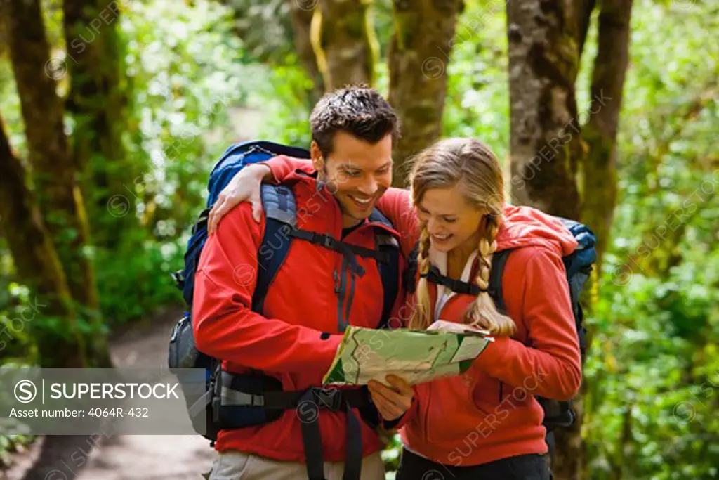 Portland, Oregon, USA, Couple hiking, stopping to reading map