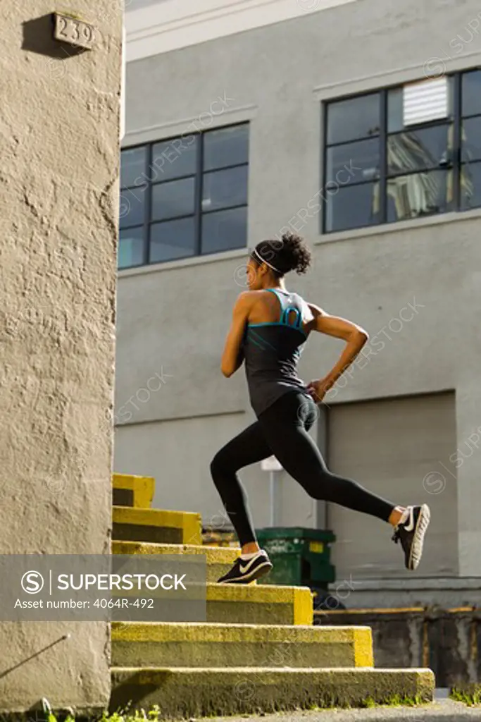 Woman jogging up steps