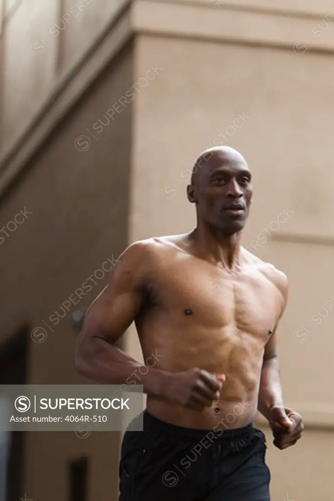 Shirtless man jogging