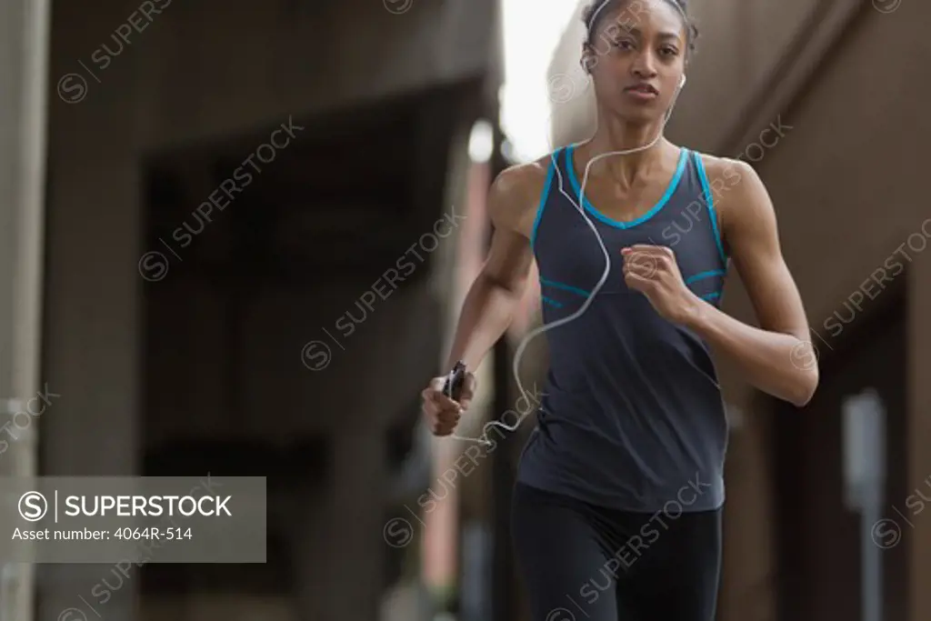 Woman listening to mp3 player while jogging