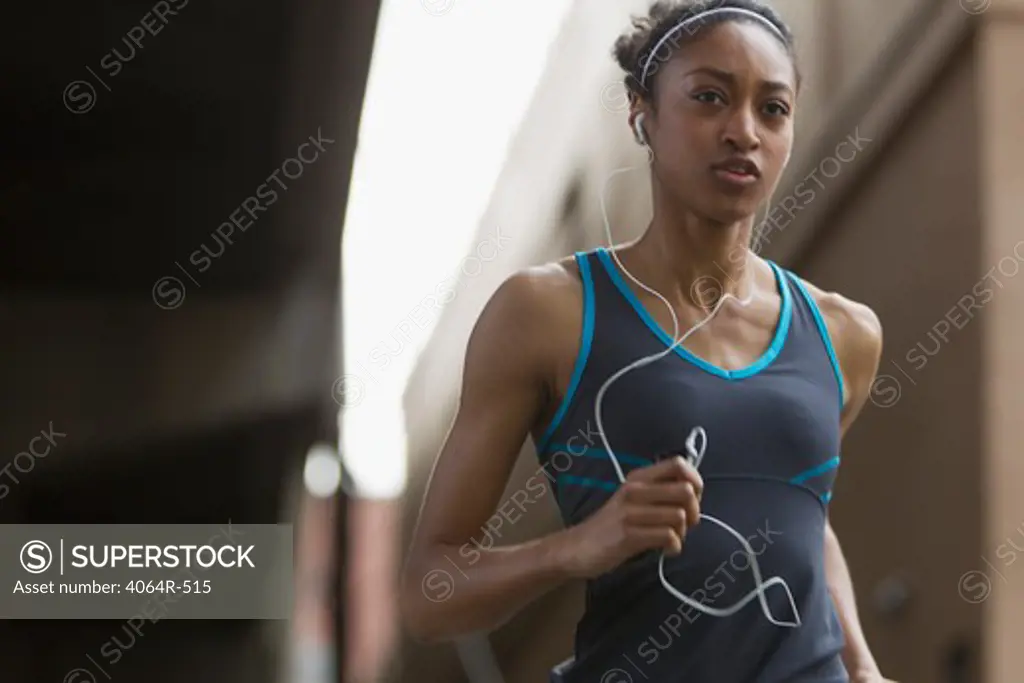 Woman listening to mp3 player while jogging